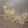 Particolare di Renna 3D con slitta piccola 80 LED bainco caldo alta 40cm in acrilico trasparente con